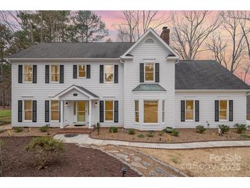 Charming two-story home features a well-maintained front yard with beautiful landscaping and classic architectural details at 125 High Sail Ct, Mooresville, NC 28117