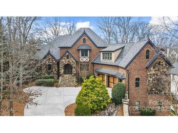 Stately brick and stone home with manicured landscaping and a welcoming front entrance at 1312 Lookout Cir, Waxhaw, NC 28173