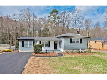 Charming single story home featuring gray siding, black shutters, and a well-maintained front yard at 1404 Nottingham Rd, Kannapolis, NC 28081