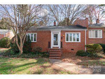 Charming brick home featuring a well-maintained yard and inviting front entrance at 1831 Jameston Dr, Charlotte, NC 28209