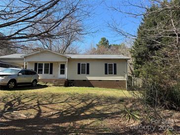 Charming single-story home with classic siding, black shutters, and a well-maintained front lawn at 303 Ellenwood Dr, Albemarle, NC 28001
