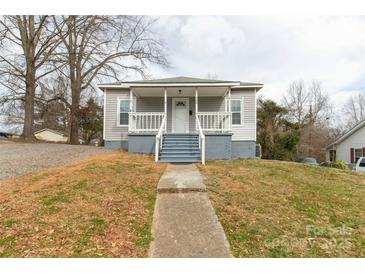 Charming single-story home with a welcoming front porch and mature trees at 305 Flat Rock St, Clover, SC 29710
