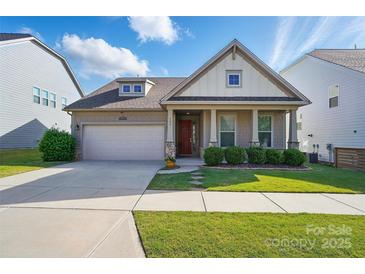 Charming single-story home featuring a two-car garage, landscaped front yard, and welcoming red front door at 333 Dudley Dr, Fort Mill, SC 29715