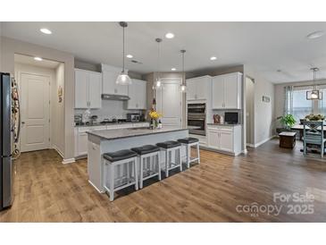 Spacious kitchen with white cabinets, granite countertops, and a large central island with seating at 333 Dudley Dr, Fort Mill, SC 29715