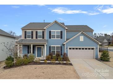 Two-story home with blue siding, black shutters, a covered front porch, and a two-car garage at 3439 Duchess Ave, Fort Mill, SC 29707