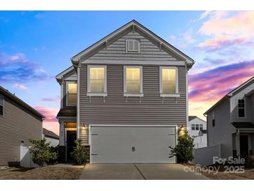 Charming two-story home featuring a gray exterior, a two-car garage, and well-maintained landscaping at 439 Newfound Hollow Dr, Charlotte, NC 28214