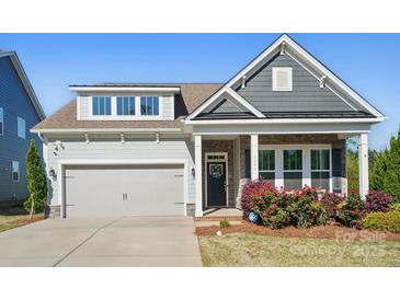 Charming home with stone accents, manicured lawn, and inviting front porch, perfect for a cozy curb appeal at 5004 Oakmere Rd, Waxhaw, NC 28173