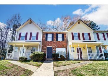 Charming townhomes with brick accents and inviting front porches, perfect for relaxing outdoors at 6210 Windsor Gate Ln, Charlotte, NC 28215