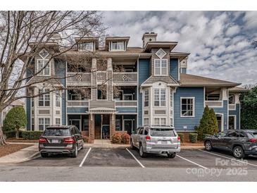Charming blue condo building with balconies and well-maintained landscaping, conveniently located near parking at 623 Olmsted Park Pl # D, Charlotte, NC 28203