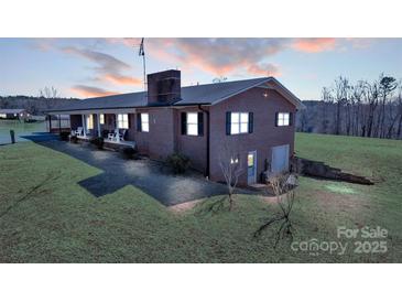Charming brick home features a large lot and a covered porch perfect for relaxing evenings at 6285 Nc 16 N Hwy, Taylorsville, NC 28681
