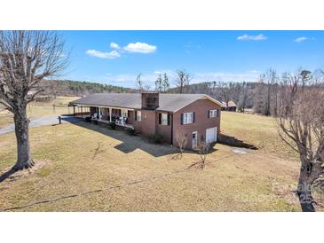 Lovely brick home with a well-manicured lawn and charming front porch, perfect for enjoying the outdoors at 6285 Nc 16 N Hwy, Taylorsville, NC 28681