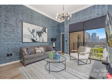 Stylish living room featuring a comfortable leather sofa, modern lighting, and a city view from the balcony at 715 N Church St, Charlotte, NC 28202