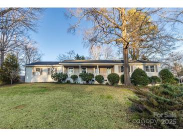 Charming single-story home features a covered front porch and meticulously maintained landscaping at 1770 Windsor Dr, Lancaster, SC 29720