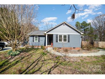 Charming single-story home with blue siding, walkway, and front yard landscaping at 240 Old Limestone E Rd, York, SC 29745