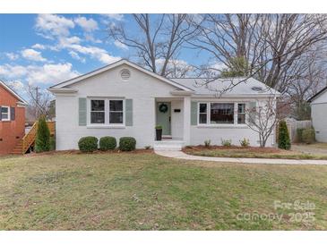 Charming one-story white brick home with a well-manicured lawn and green shutters at 3504 Meredith Ave, Charlotte, NC 28208