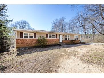 Charming single-story home with brick accents and a well-maintained yard on a sunny day at 4211 Little Mountain Rd, Gastonia, NC 28056