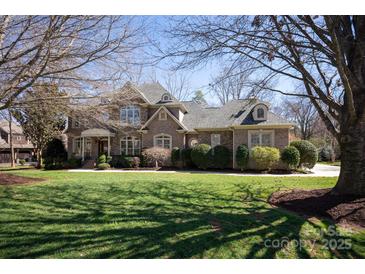 Beautiful brick home featuring a well-manicured lawn and mature trees in a desirable neighborhood at 425 Gladelynn Way, Waxhaw, NC 28173