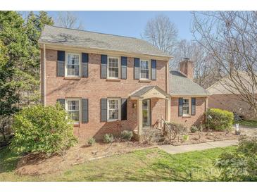 Charming two-story brick home with black shutters and a well-manicured front yard at 4840 Autumn Leaf Ln, Charlotte, NC 28277