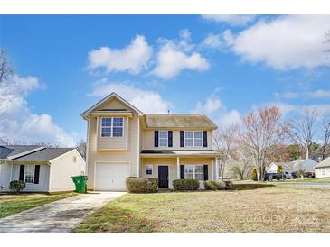 Charming two-story home with a well-manicured lawn and a one car garage at 8247 Pozzi Rd, Charlotte, NC 28216