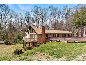 Charming single-story home with a brick facade, deck, and lush green lawn at 1109 Hemlock Dr, Shelby, NC 28150