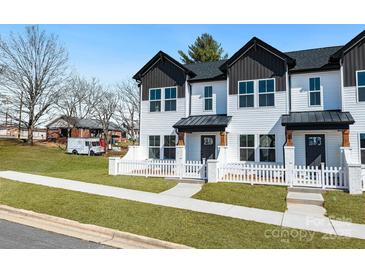 Inviting new construction townhouse with white picket fence and manicured lawn at 211 E Rice St, Landis, NC 28088