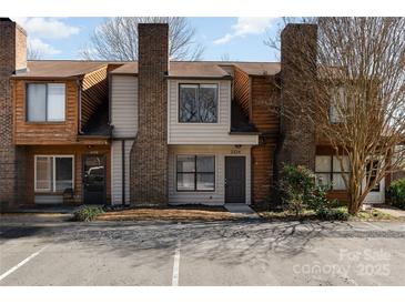 A charming townhome with a brick chimney and inviting curb appeal at 2324 Brookview Ct, Rock Hill, SC 29732