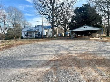 Charming two-story home with a covered carport, set on a spacious lot with mature trees at 2940 Ambrose Dr, Gastonia, NC 28056