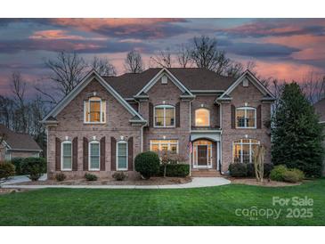 Beautiful brick two-story home with manicured lawn and professional landscaping at 409 Conaway Ct, Waxhaw, NC 28173