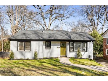 Charming home with a freshly painted white brick exterior, complemented by a well-manicured front yard at 4308 Welling Ave, Charlotte, NC 28208