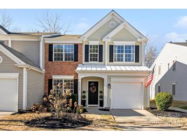 Charming two-story home featuring black shutters, an attached garage, and an inviting front entrance at 11708 Huxley Rd, Charlotte, NC 28277