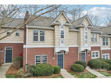 Charming townhome with brick and shingle exterior, featuring a well-manicured front yard and inviting entrance at 3010 Uxbridge Woods Ct, Charlotte, NC 28205