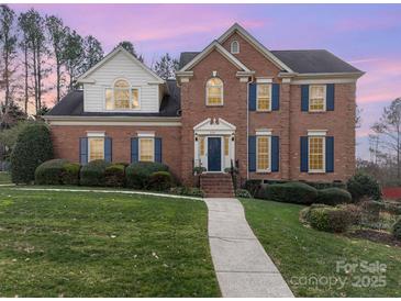 Traditional brick home with manicured lawn, walkway, blue shutters, and a gabled roof on a sunny day at 3101 Colvard Park Way, Charlotte, NC 28269