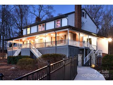 Stunning two-story home with a large, inviting porch and manicured landscaping, perfect for outdoor living at 368 Fairfield Ct, Mount Gilead, NC 27306