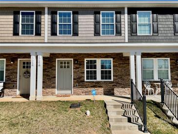 Charming townhome showcasing a welcoming stone facade, neat landscaping, and a quaint covered entrance at 3726 Windy Pine Nw Ln, Hickory, NC 28601