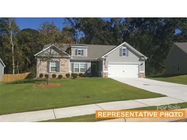 Charming two-story home with stone accents, a manicured lawn, and a two-car garage at 6347 Honor Ave, Midland, NC 28107