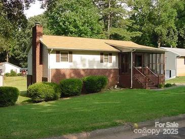 Charming single-story home with brick accents, a screened porch, and a well-maintained lawn at 806 Boyce St, Kings Mountain, NC 28086