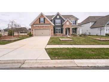 Charming two-story home with a well-manicured lawn, stone accents, and an attached two-car garage at 9300 Vecchio Dr, Indian Land, SC 29707