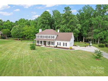 Stunning two-story home with a lush green lawn and mature trees at 1226 Flint Ct, Matthews, NC 28104