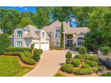 Stunning two-story home with a manicured lawn, driveway, and three-car garage at 17048 Jetton Rd, Cornelius, NC 28031