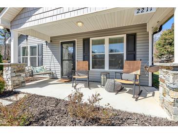 Charming front porch with rocking chairs and swing, perfect for relaxing outdoors at 2211 Waverly St, Albemarle, NC 28001