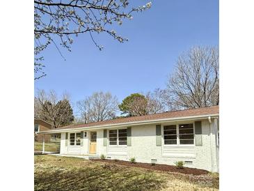 Charming white brick single-story home with inviting curb appeal and beautifully landscaped front yard at 2232 Glenraven Ave, Gastonia, NC 28052