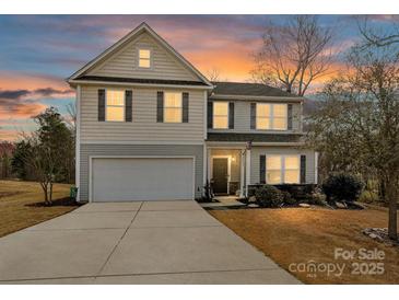 Charming two-story home featuring a two-car garage and a well-manicured lawn at 2437 Grinstead Ct, Clover, SC 29710