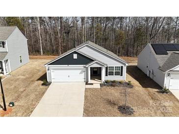 Charming home featuring an attached garage, tidy landscaping, and gray siding at 3122 Maple Ridge Dr, Gastonia, NC 28052