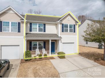 Charming two-story home featuring a cozy front porch, a well-maintained lawn, and an attached single-car garage at 4075 Creekstone Trce, Gastonia, NC 28056