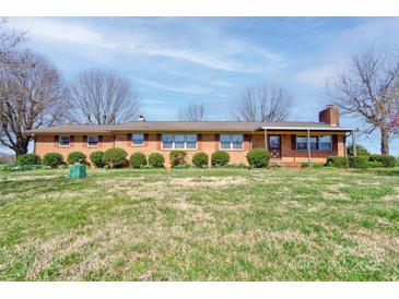 Charming brick ranch home featuring manicured landscaping and a well-maintained lawn at 5830 W Nc 10 Hwy, Hickory, NC 28602