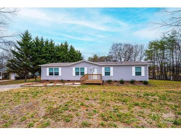 Charming single-story home features a wooden porch, well-maintained lawn, and picturesque landscaping at 80 Sunset Dr, Taylorsville, NC 28681