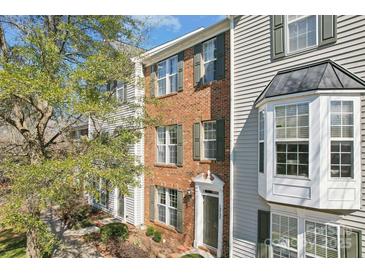 Charming two-story townhome with brick facade, neutral siding, and professionally landscaped front yard at 12727 Bullock Greenway Blvd, Charlotte, NC 28277