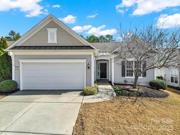 Charming single-story home with a two-car garage, manicured lawn, and inviting entrance at 41062 Calla Lily St, Fort Mill, SC 29707