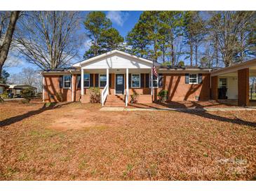 Charming brick home with a welcoming front porch and well-maintained landscaping at 571 Amity Se Ave, Concord, NC 28025