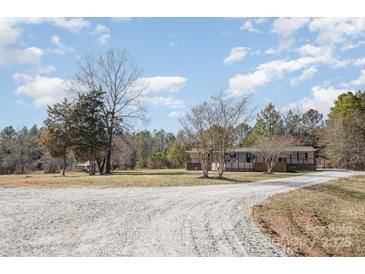 Charming ranch home featuring a long gravel driveway and inviting front porch at 620 Debruhl Rd, Chester, SC 29706